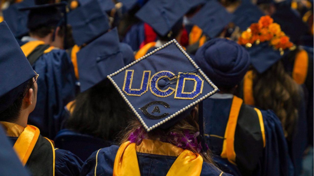 UC Davis graduates with a focus on a graduation cap