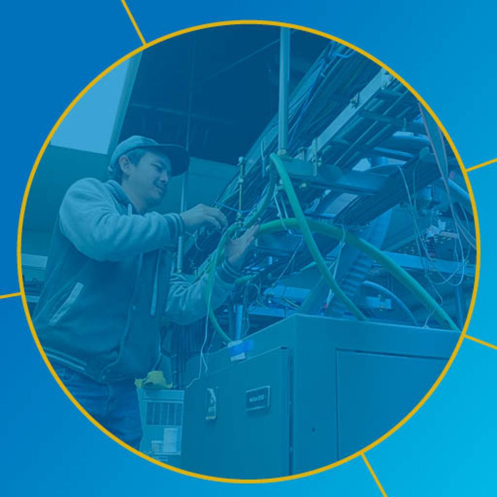 Person working with wiring on electrical equipment