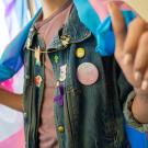 Person wearing denim jacket with buttons